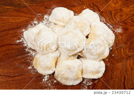 Tortellini on a wooden table 23430712