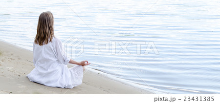 Woman meditating at the sea 23431385