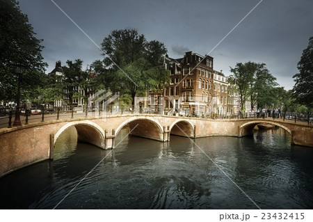 Amsterdam canals with bridge and typical houses, Holland Amsterdam canals with bridge and typical houses, Holland 23432415