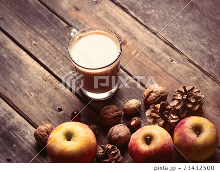 apples, fir-cones, cup of coffee and nuts 23432500