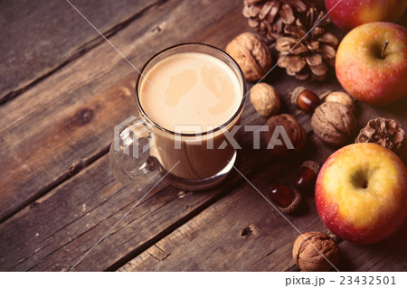 apples, fir-cones, cup of coffee and nuts 23432501