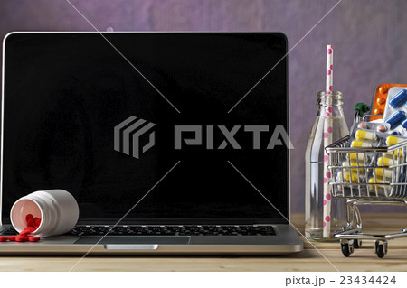 Scattered pills on the laptop keyboard Scattered pills on the laptop keyboard 23434424