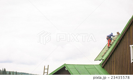 Man Working on the Roof, Sandering Paint Man Working on the Roof, Sandering Paint 23435578