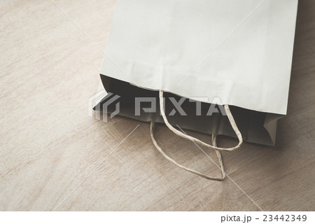 Paper bag on a wooden background 23442349