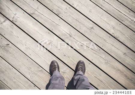 Male feet in leather shoes stand on old pier 23444103