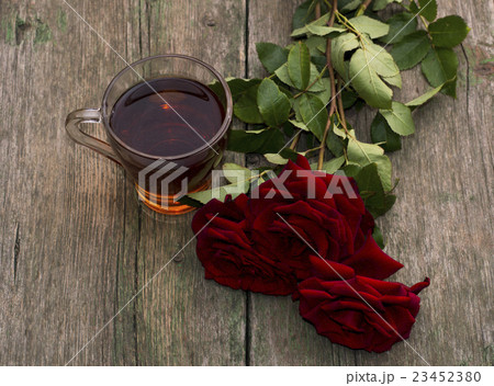 cup of tea and three red beautiful roses cup of tea and three red beautiful roses 23452380