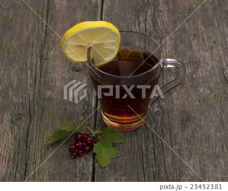 cup of tea with a lemon decorated with currant 23452381