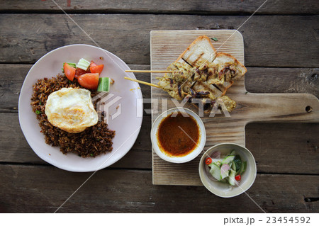 Malaysian food chicken satay with peanut sauce on wood background Malaysian food chicken satay with peanut sauce on wood background 23454592