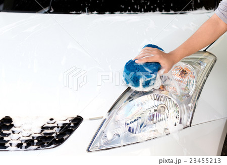 hand using sponge washing car 23455213