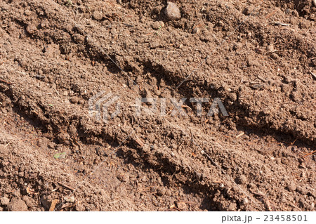 Brown dry plowed soil surface with grooves Brown dry plowed soil surface with grooves 23458501