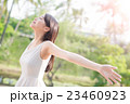 young woman raising her arms 23460923