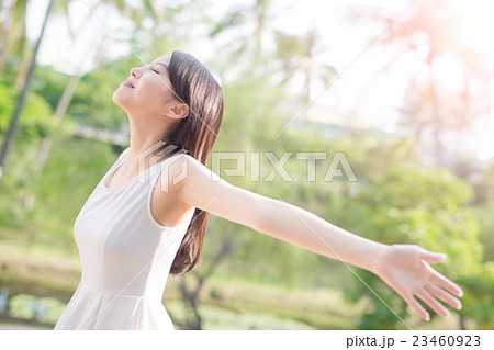 young woman raising her arms 23460923
