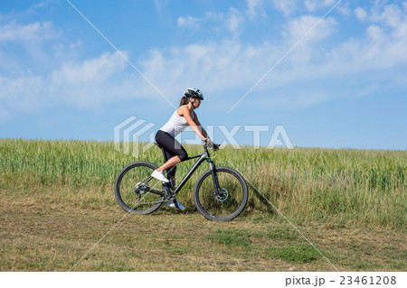 Happy Young Woman riding bicycle outside 23461208