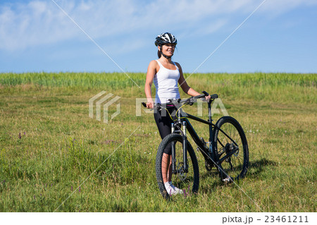 Happy Young Woman riding bicycle outside 23461211