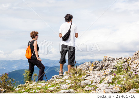 man and woman on a summer walk in the mountains 23461716