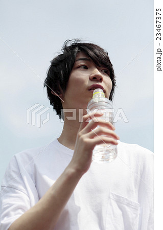 水を飲んでくつろぐ若い男性横目線 水を飲んでくつろぐ若い男性横目線 23467375