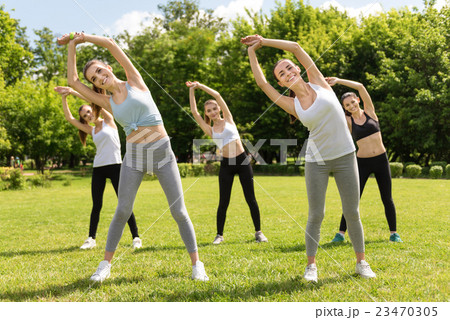 Positive women doing sport exercises outdoors Positive women doing sport exercises outdoors 23470305