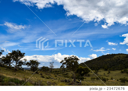 Rural landscape with mountains & overcast blue sky 23472676