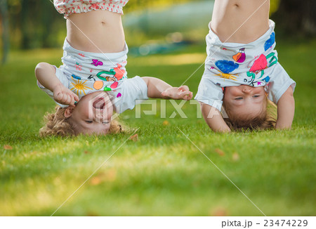 The two little baby girls hanging upside down 23474229