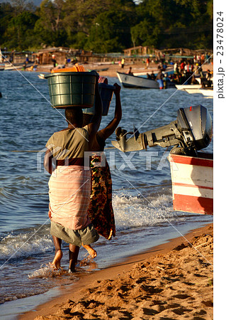 漁村のビーチを歩くアフリカ女性 23478024