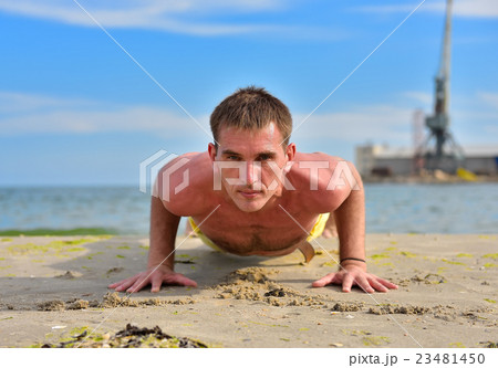 yoga man in a dog pose yoga man in a dog pose 23481450