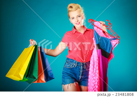 Pinup girl with shopping bags buying dress. Sale Pinup girl with shopping bags buying dress. Sale 23481808