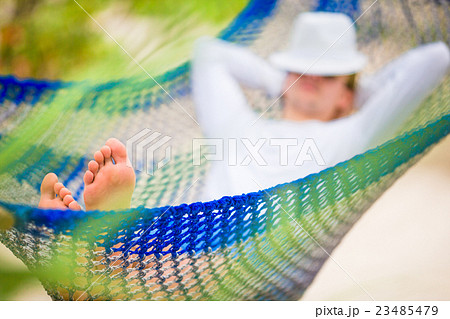 Lazy time. Man in hat in a hammock on a summer day Lazy time. Man in hat in a hammock on a summer day 23485479