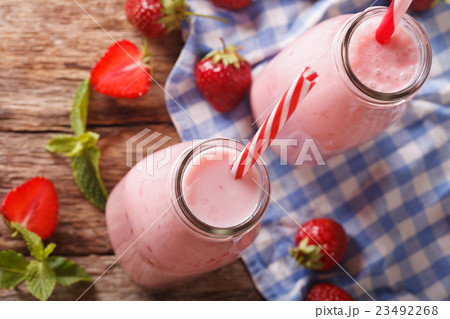 Fresh strawberry milkshake in glass bottles 23492268