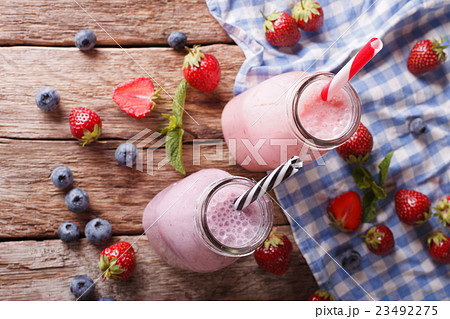Milkshakes with strawberries and blueberries Milkshakes with strawberries and blueberries 23492275
