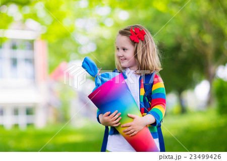 Little child with candy cone on first school day 23499426