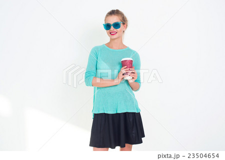 Beautiful female holding cup of hot coffee to go 23504654