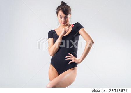 Young brunette model with lollipop studio shot on 23513671