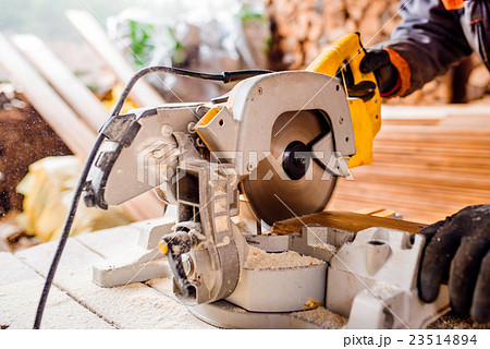 Carpenter working. Man cutting plank by circular Carpenter working. Man cutting plank by circular 23514894