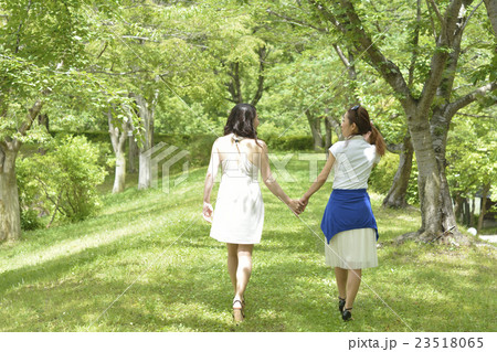 Two Women Holding Hands Stock Photo