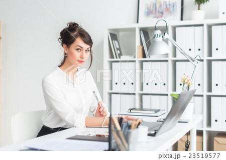 Close-up portrait of a businesswoman at her Close-up portrait of a businesswoman at her 23519577