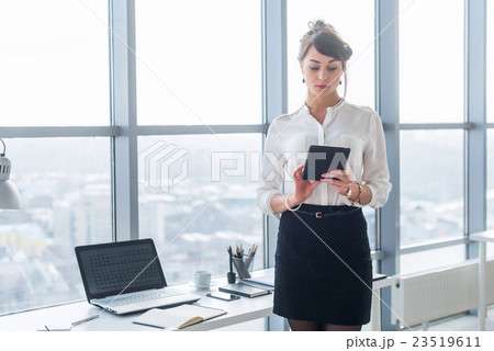 Rear view portrait of a young female office worker Rear view portrait of a young female office worker 23519611