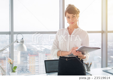 Close-up portrait of a young confident female 23519614