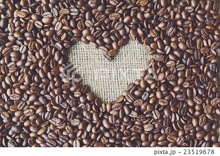Coffee beans background with burlap heart frame Coffee beans background with burlap heart frame 23519678
