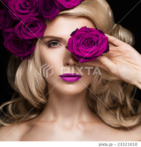 Beautiful blond girl in dress and hat with roses Beautiful blond girl in dress and hat with roses 23521010