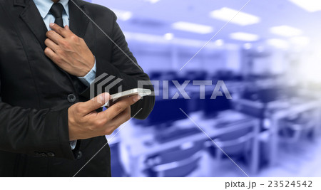 Businessman using the smart phone on Abstract blurred photo of empty computer room, education and business concept Businessman using the smart phone on Abstract blurred photo of empty computer room, education and business concept 23524542