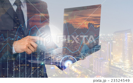 Double exposure of businessman using the laptop computer with cityscape and financial graph on blurred building background, Business Trading concept Double exposure of businessman using the laptop computer with cityscape and financial graph on blurred building background, Business Trading concept 23524549
