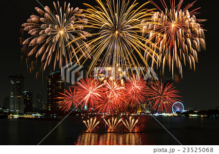 Fantastic fireworks over the river with cityscape at night scene background 23525068