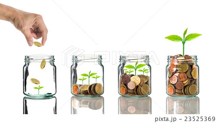 Hand putting gold coins into clear bottle on white background,Business investment growth concept Hand putting gold coins into clear bottle on white background,Business investment growth concept 23525369