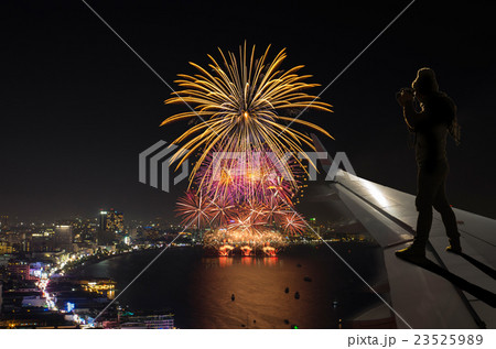 silhouette of photographer taking photo on airplane wing which can see Fantastic festive colorful fireworks, Challenge and success business concept silhouette of photographer taking photo on airplane wing which can see Fantastic festive colorful fireworks, Challenge and success business concept 23525989