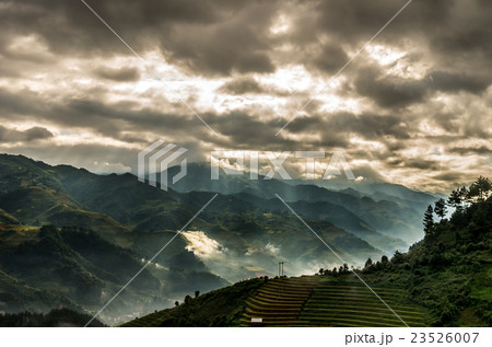 Rice fields on terraced of Mu Cang Chai District at sunrise time with sun ray, YenBai province, Northwest Vietnam, worm tone Rice fields on terraced of Mu Cang Chai District at sunrise time with sun ray, YenBai province, Northwest Vietnam, worm tone 23526007