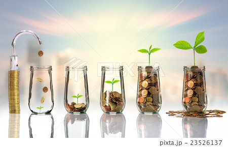 Faucet putting Gold coins and seed in clear bottle on cityscape photo blurred cityscape background,Business investment growth concept Faucet putting Gold coins and seed in clear bottle on cityscape photo blurred cityscape background,Business investment growth concept 23526137