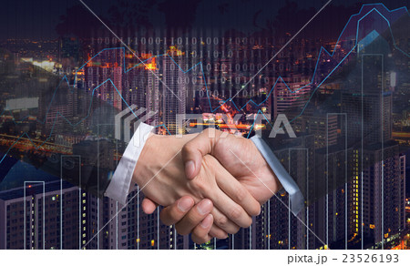 Hand shake between businessman on Trading graph on the cityscape at night and world map background,Business financial concept 23526193
