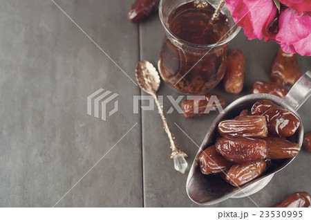 Traditional arabic tea and dry dates. 23530995