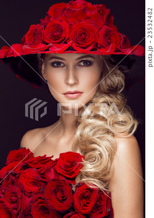 Beautiful blond girl in dress and hat with roses 23532482