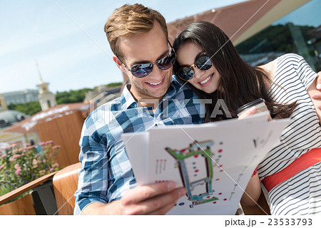 Positive couple sitting on the bench 23533793